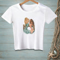 White t-shirt graphic featuring two mermaids sitting on a wooden dock looking in a mirror.