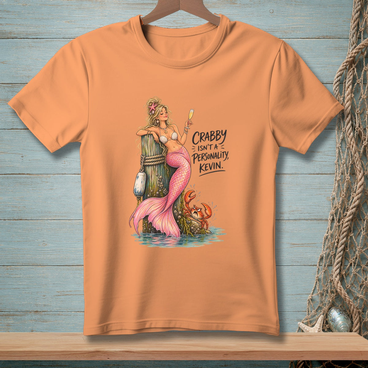 Mermaid with pink tail and crab on a post, text says "Crabby isn't a personality, Kevin."