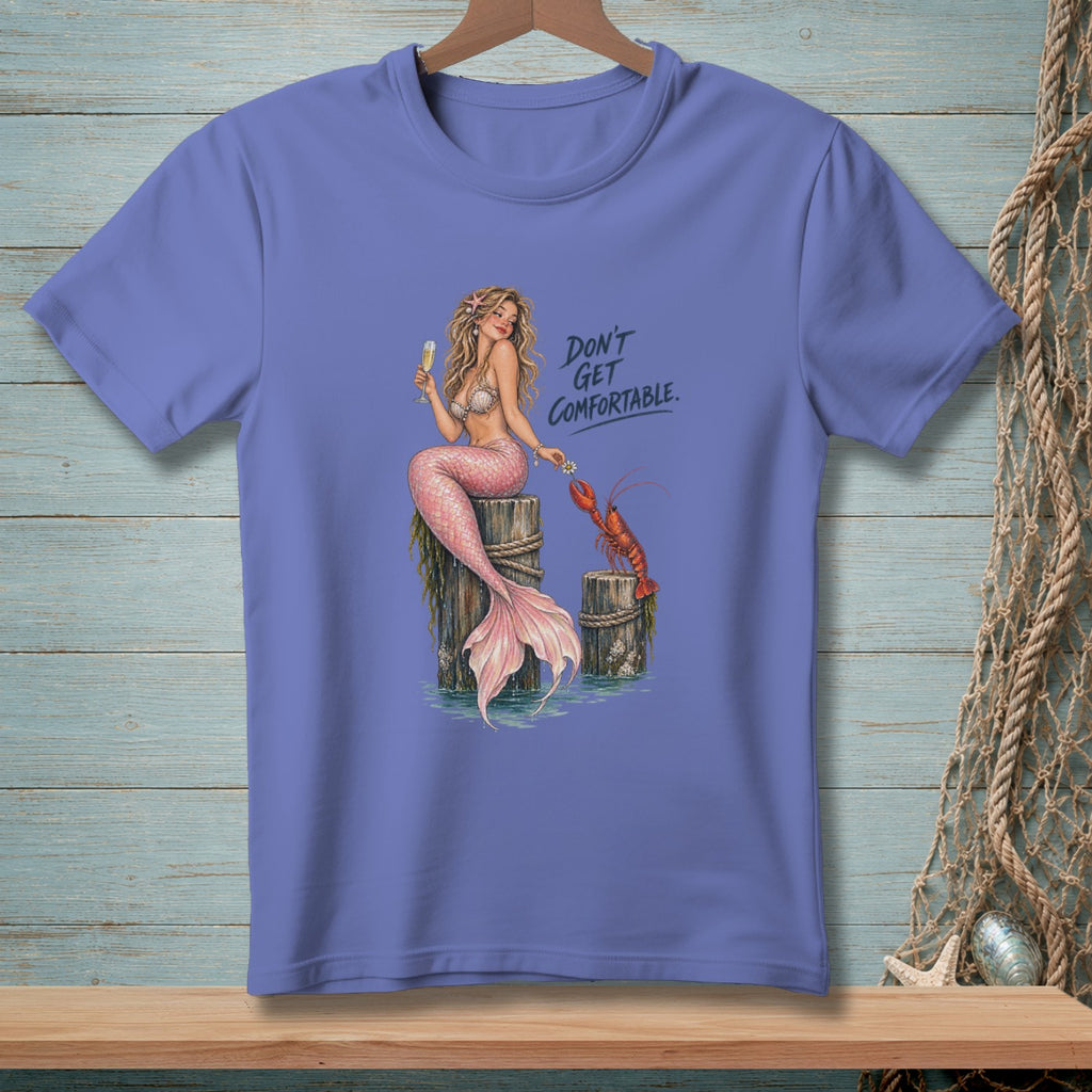 T-shirt with a mermaid, lobster, champagne, and the text "DON'T GET COMFORTABLE."