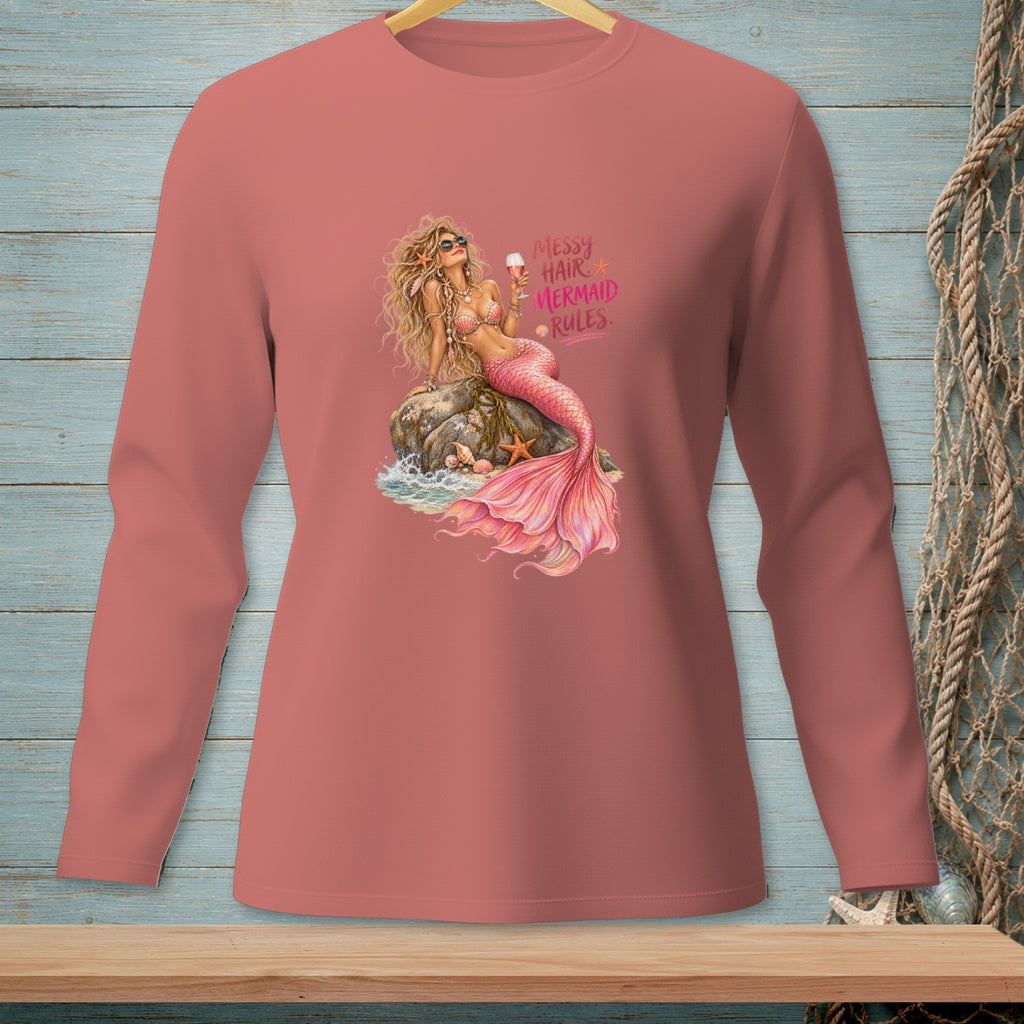 Mermaid with pink tail and sunglasses sits on a rock holding a drink.