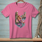 Pink t-shirt with mermaid, crab, gift bag, and waterfront scene illustration.