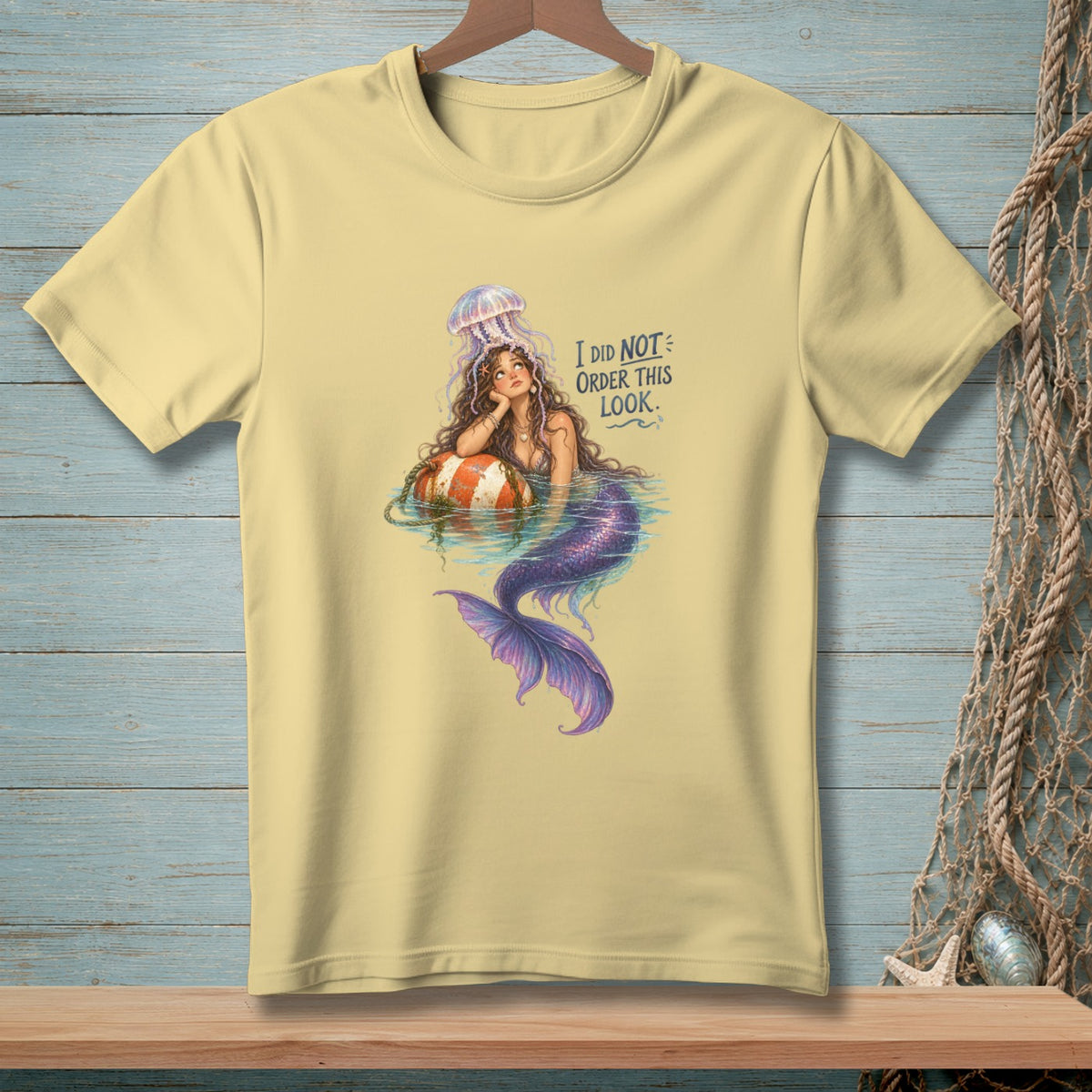 Light yellow t-shirt with a mermaid artwork and text "I DID NOT ORDER THIS LOOK."