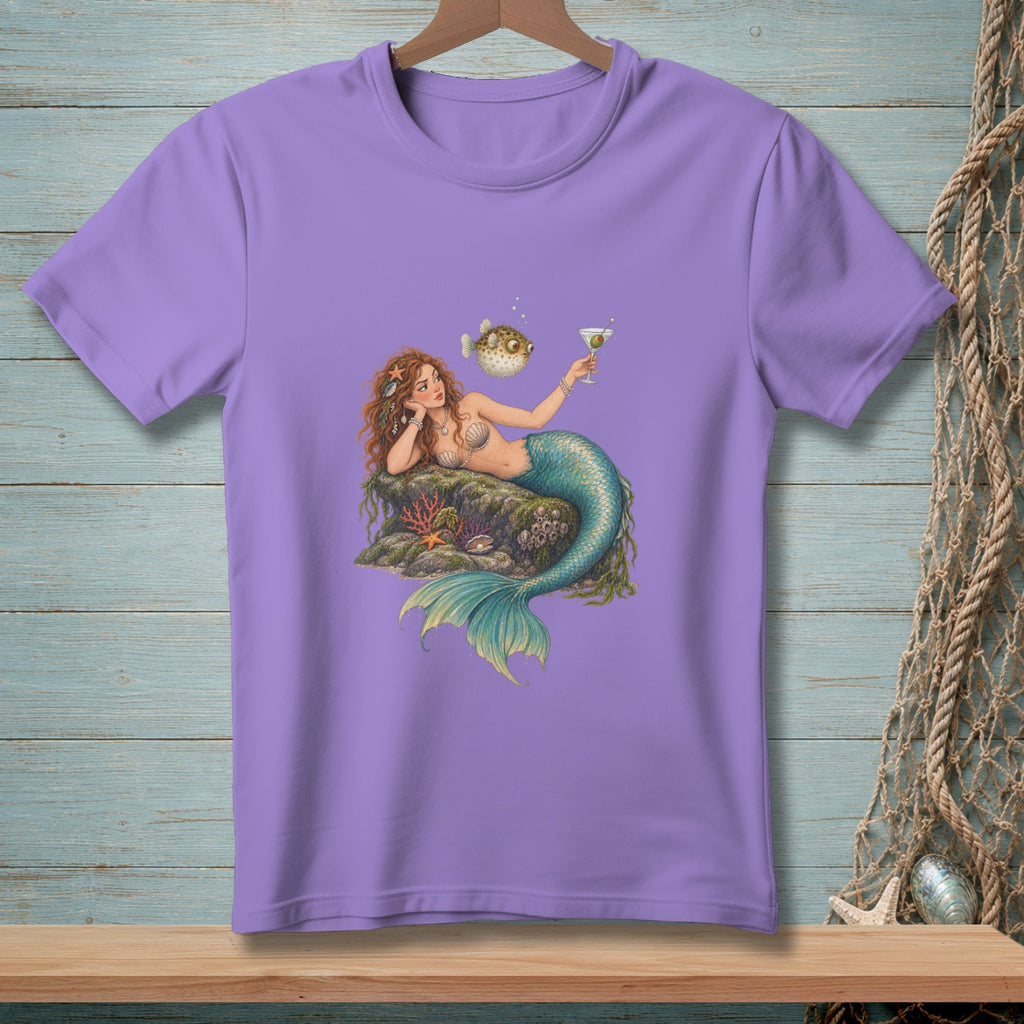 Mermaid with a pufferfish and martini on a rock, printed on a lavender t-shirt.