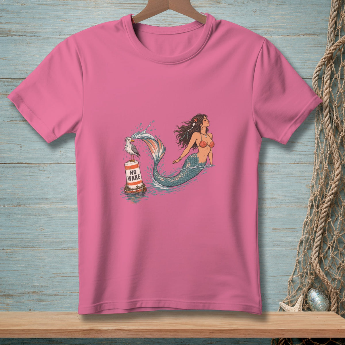 Pink t-shirt with a mermaid and a seagull on a "No Wake" buoy.