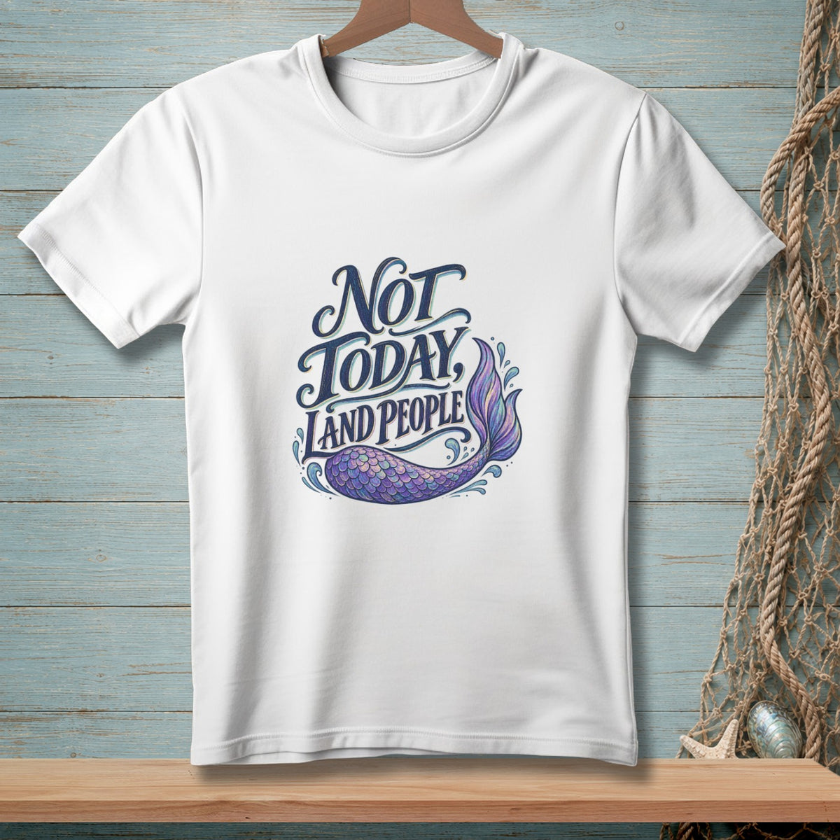 White t-shirt with "Not Today, Land People" and a purple mermaid tail graphic.