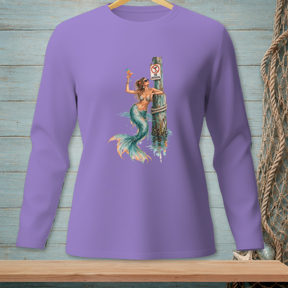 Purple long-sleeve shirt with a graphic of a mermaid holding a drink near a post with a "No Drinking" sign.