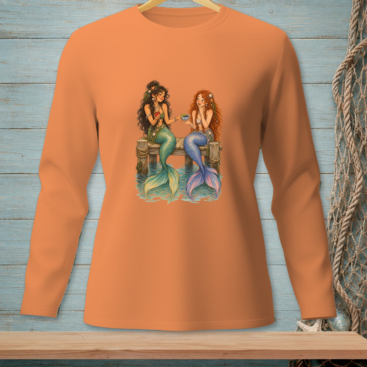Two mermaids sit on a dock sharing tea, with detailed tails and ocean-themed accessories.