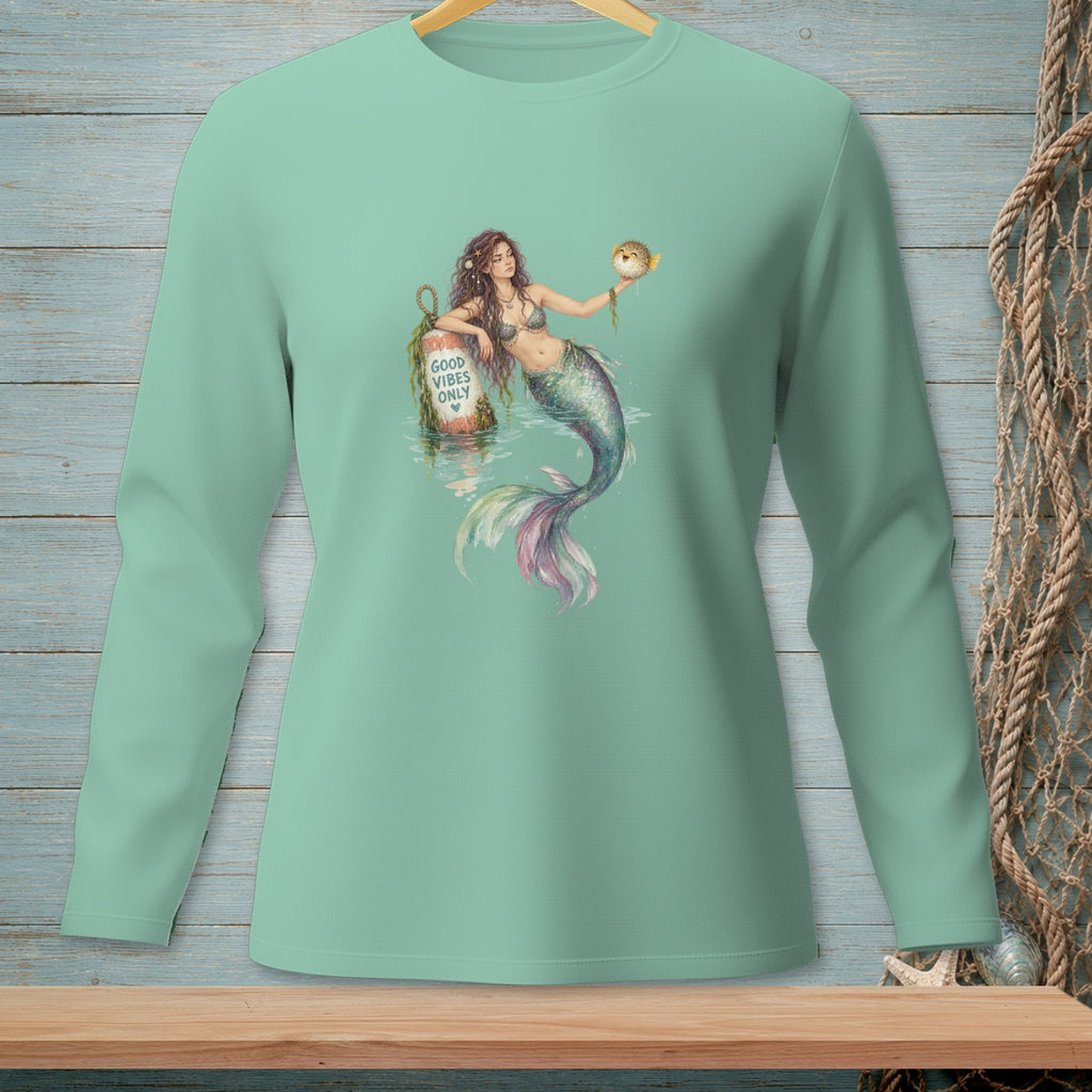 Mermaid holding a pufferfish next to a buoy reading "Good Vibes Only".