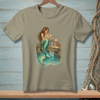 Mermaid on a dock reading mail with a crab and cocktail.