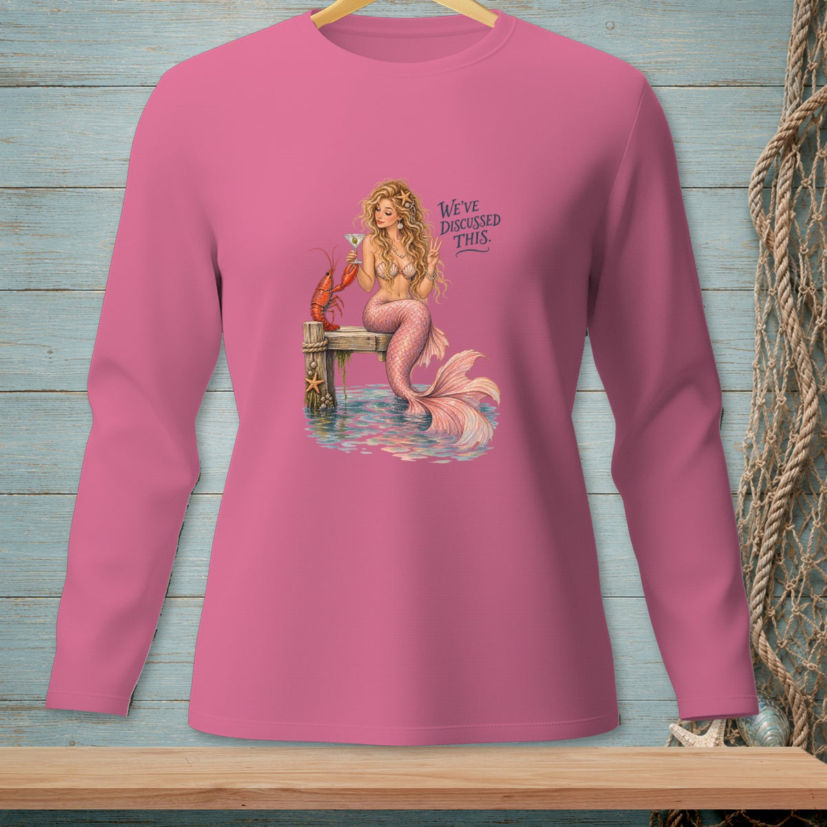 Pink long-sleeve shirt with mermaid, lobster, and "WE'VE DISCUSSED THIS." text.