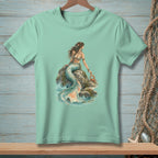 Mint t-shirt with a mermaid sitting on a rock with a crab holding a "Smile" sign.