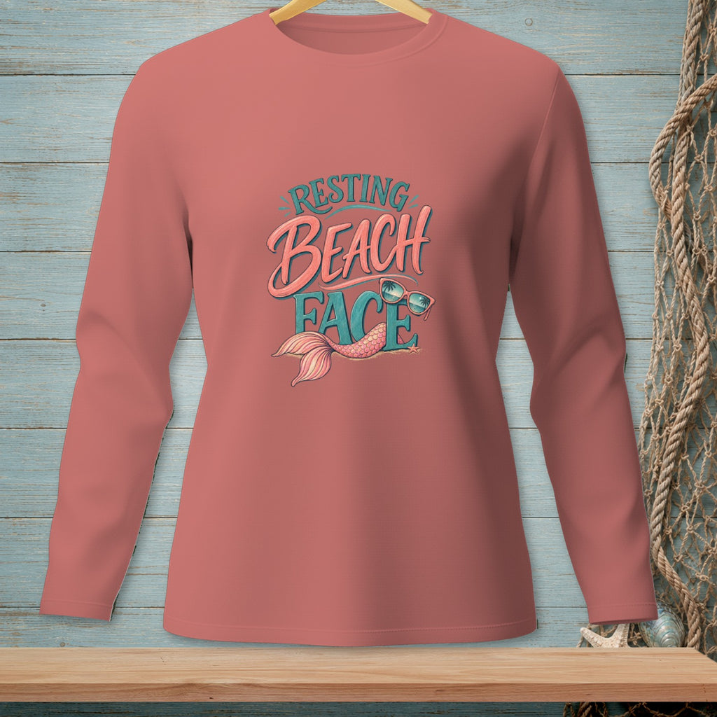 Pink long-sleeve shirt with "Resting Beach Face" text and a mermaid tail graphic.