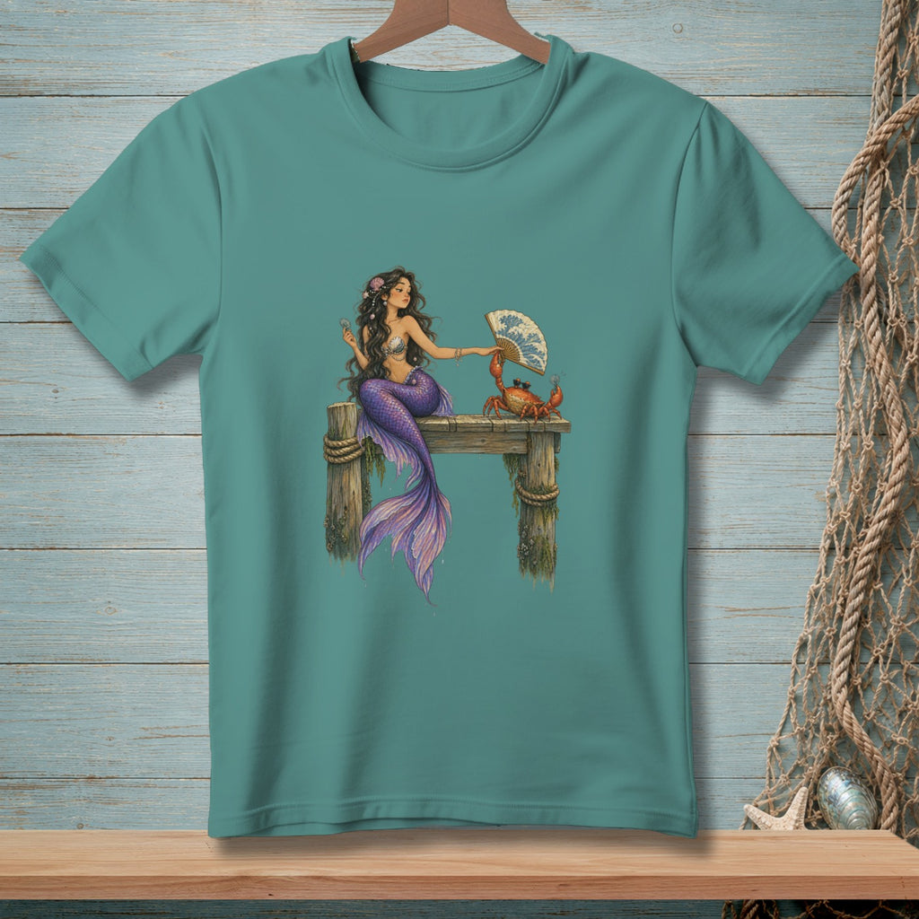 Mermaid sitting on a dock holding a fan towards a crab.