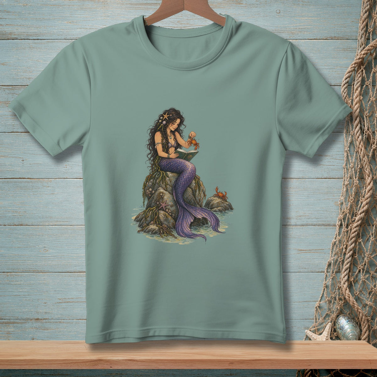 Mermaid reading a book on a rock with crabs and starfish.