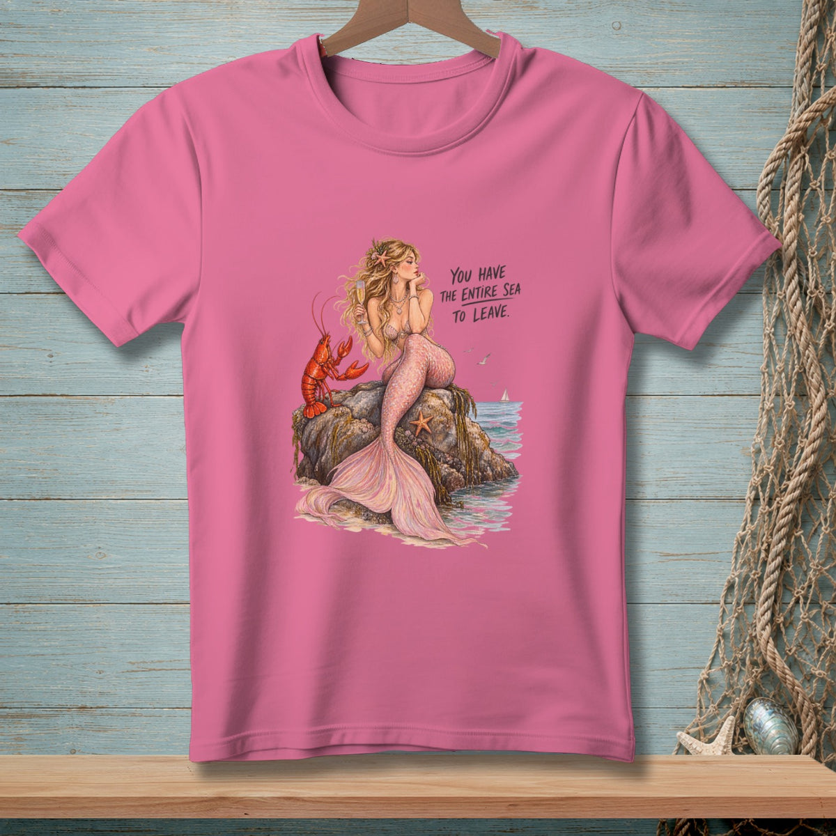 Pink t-shirt with mermaid, lobster, and text: "You have the entire sea to leave."