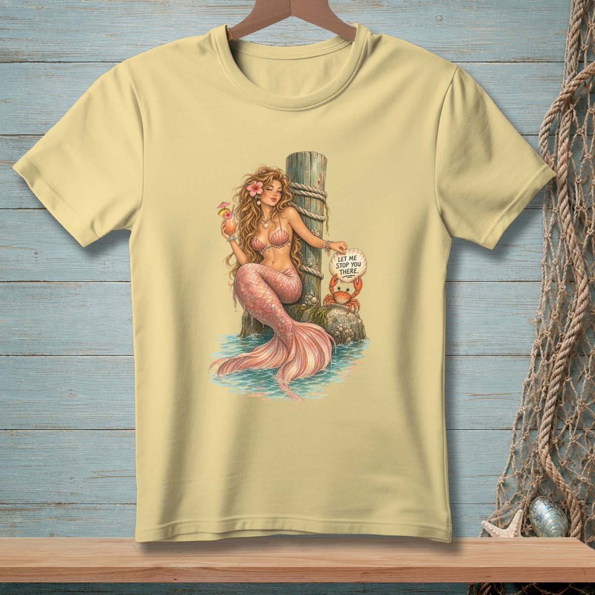 Yellow t-shirt with illustration of a mermaid holding a drink, a crab, and text.