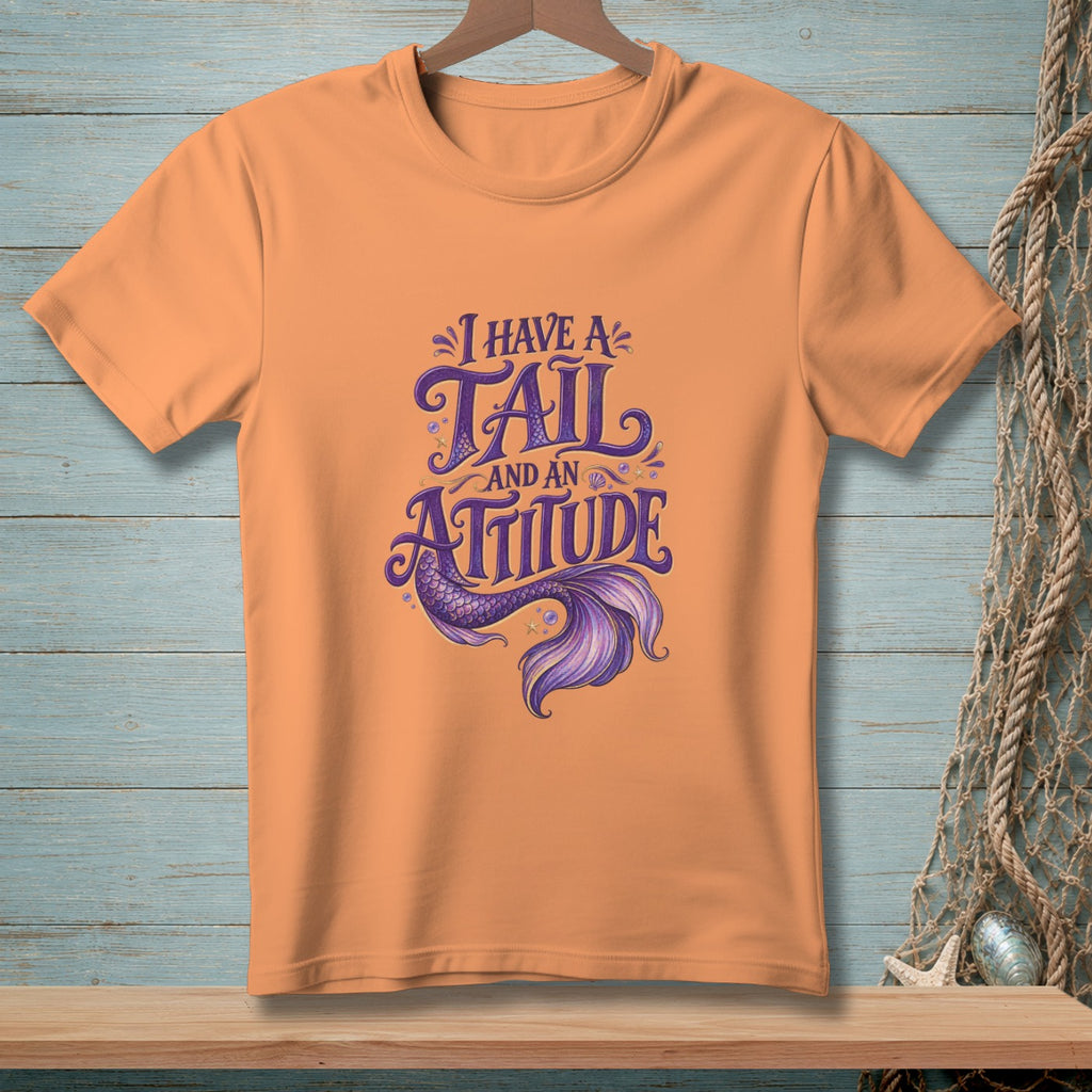Orange t-shirt with "I HAVE A TAIL AND AN ATTITUDE" mermaid graphic.
