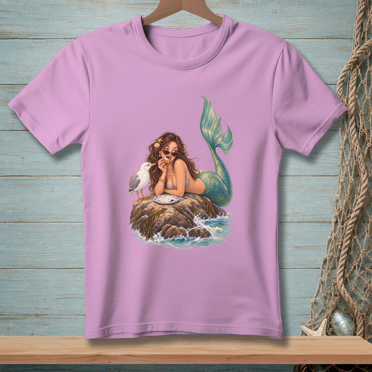Mermaid with sunglasses eating pizza on a rock with a seagull and waves.