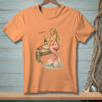 Orange t-shirt with mermaid, champagne, and crab on a pier.