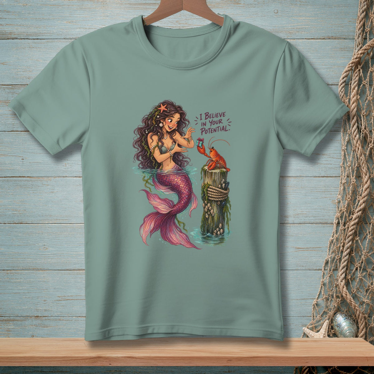 Mermaid with pink tail and lobster, with text "I BELIEVE IN YOUR POTENTIAL."