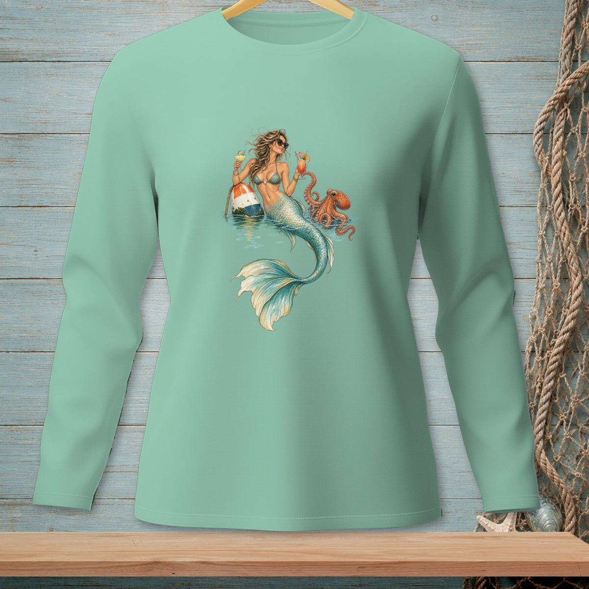 Mermaid with drinks and octopus on a mint green long sleeve shirt.
