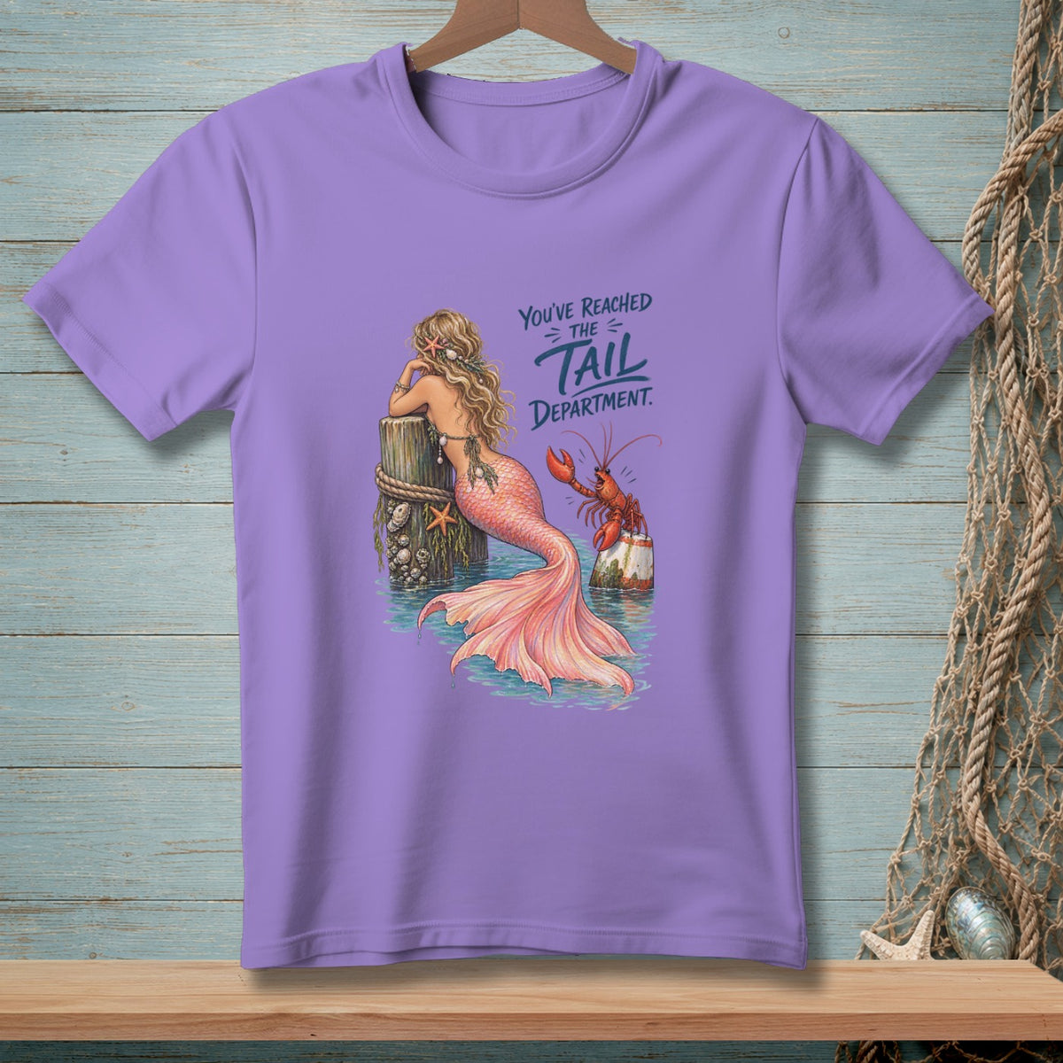 Purple t-shirt with mermaid and lobster graphic and "You've Reached The Tail Department" text.