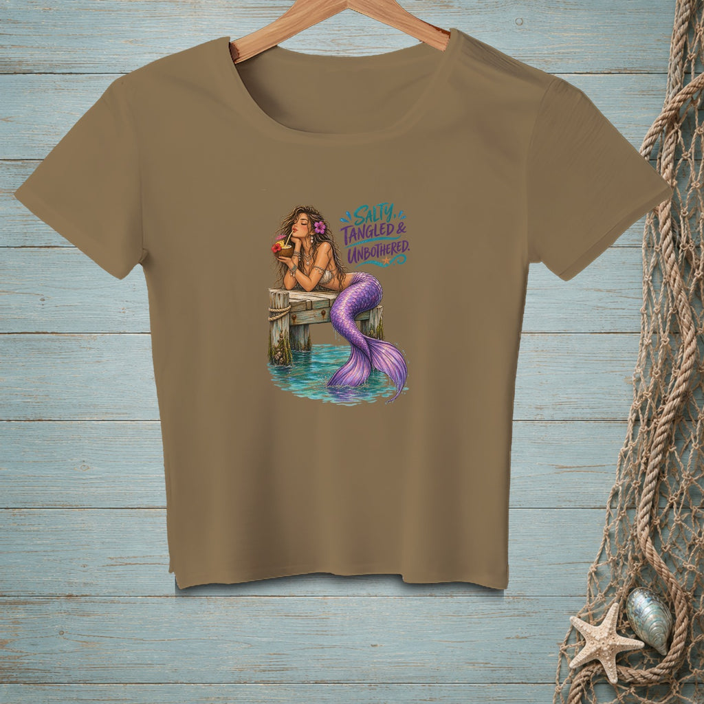 Brown t-shirt with a mermaid holding a drink on a pier, text "SALTY, TANGLED & UNBOTHERED".