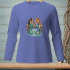Two mermaids with long hair sit talking on a wooden pier above the water.