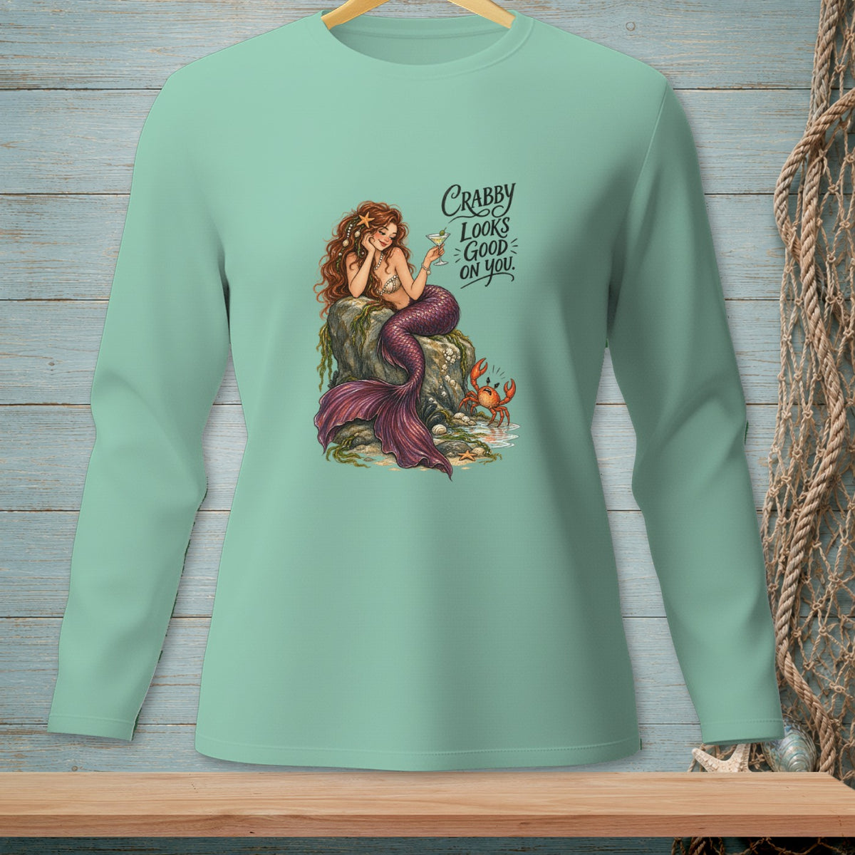 Green long-sleeve shirt with a mermaid, crab, and text "Crabby looks good on you."