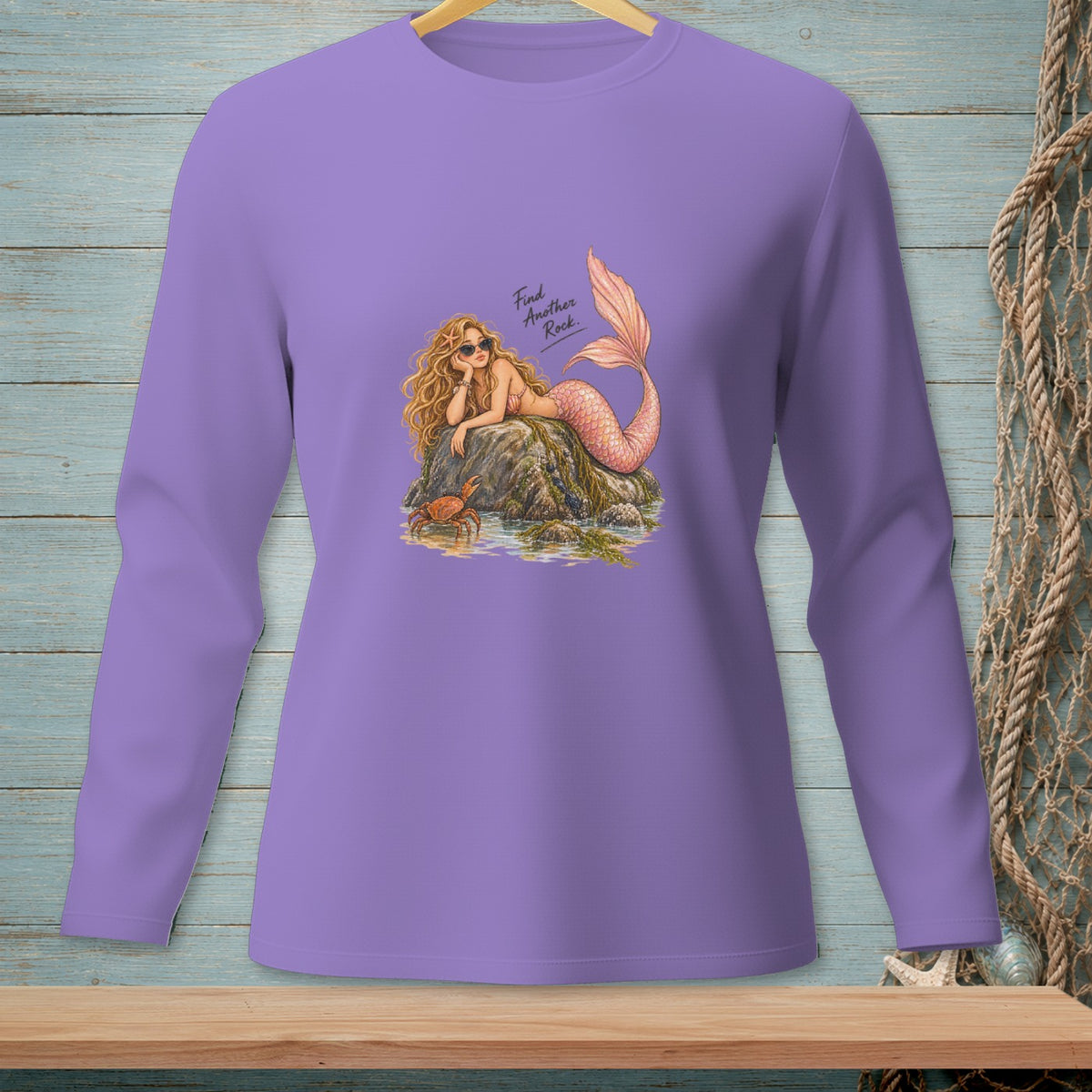 Lavender long-sleeve shirt with a mermaid graphic and text "Find Another Rock".