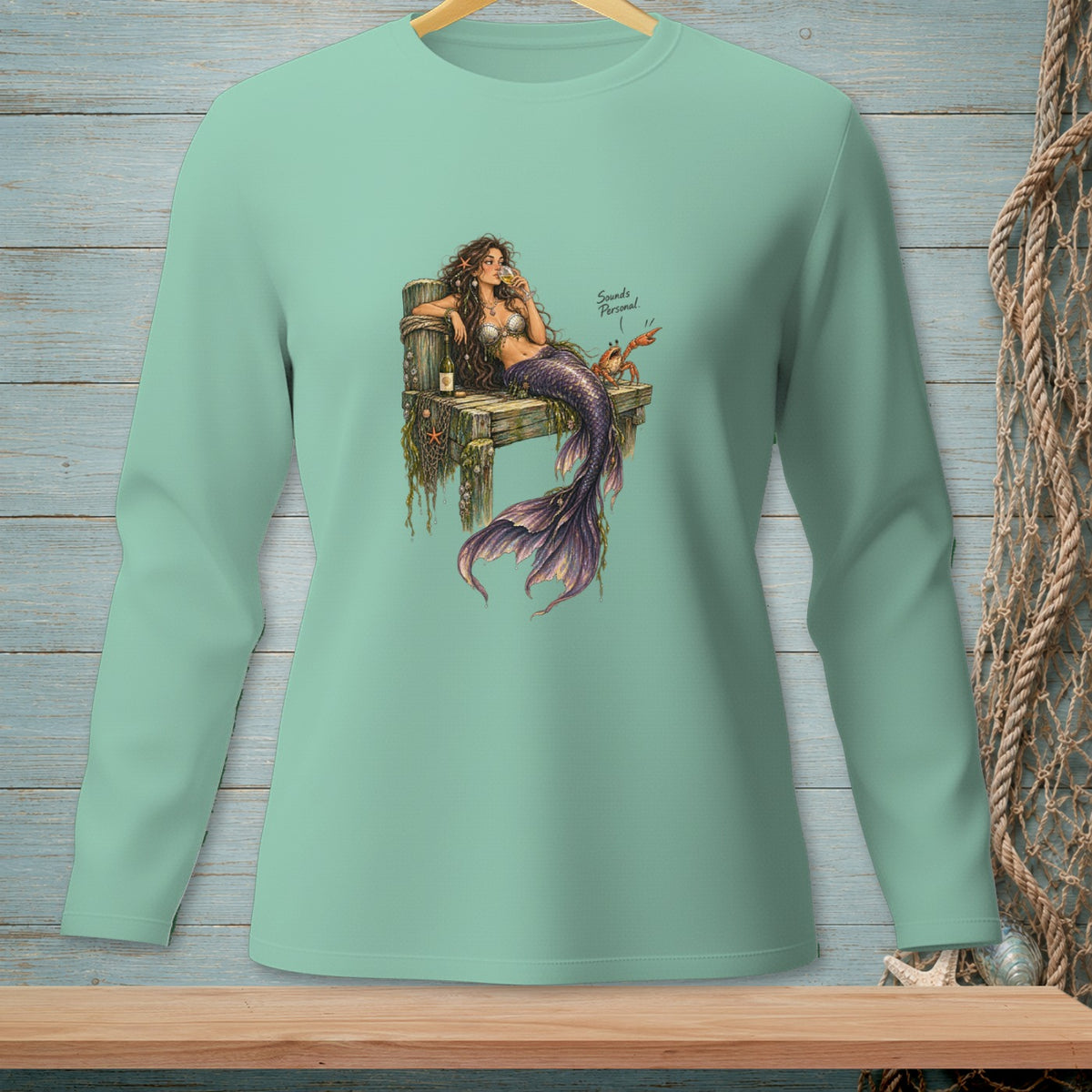Mermaid on pier with wine and crab, text reads "Sounds Personal."
