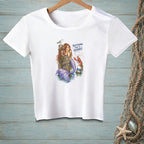 White t-shirt with a mermaid, lobster, seagull, and text that reads "Keep Going. This Is Adorable."