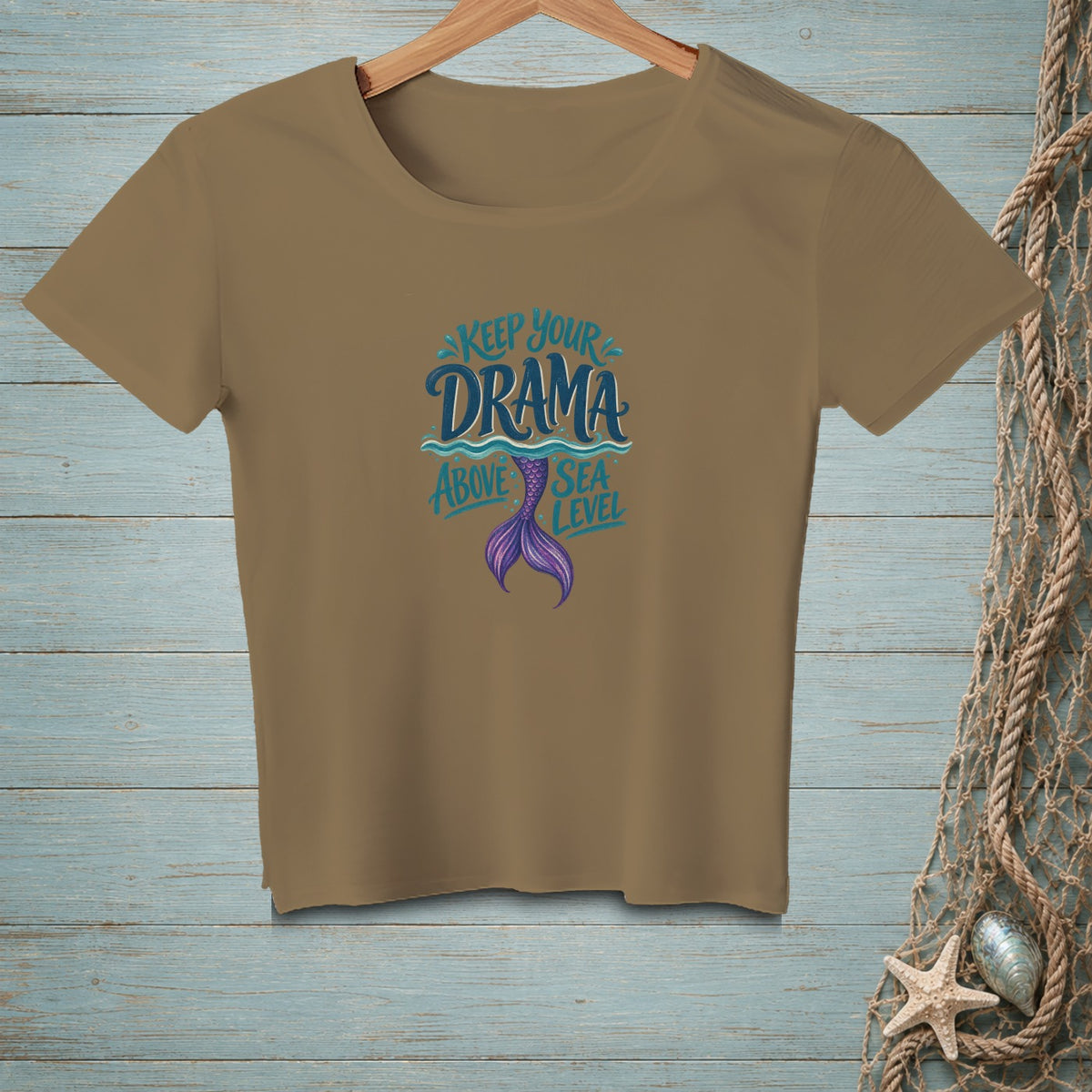 Tan t-shirt with "Keep Your Drama Above Sea Level" and a purple mermaid tail design.