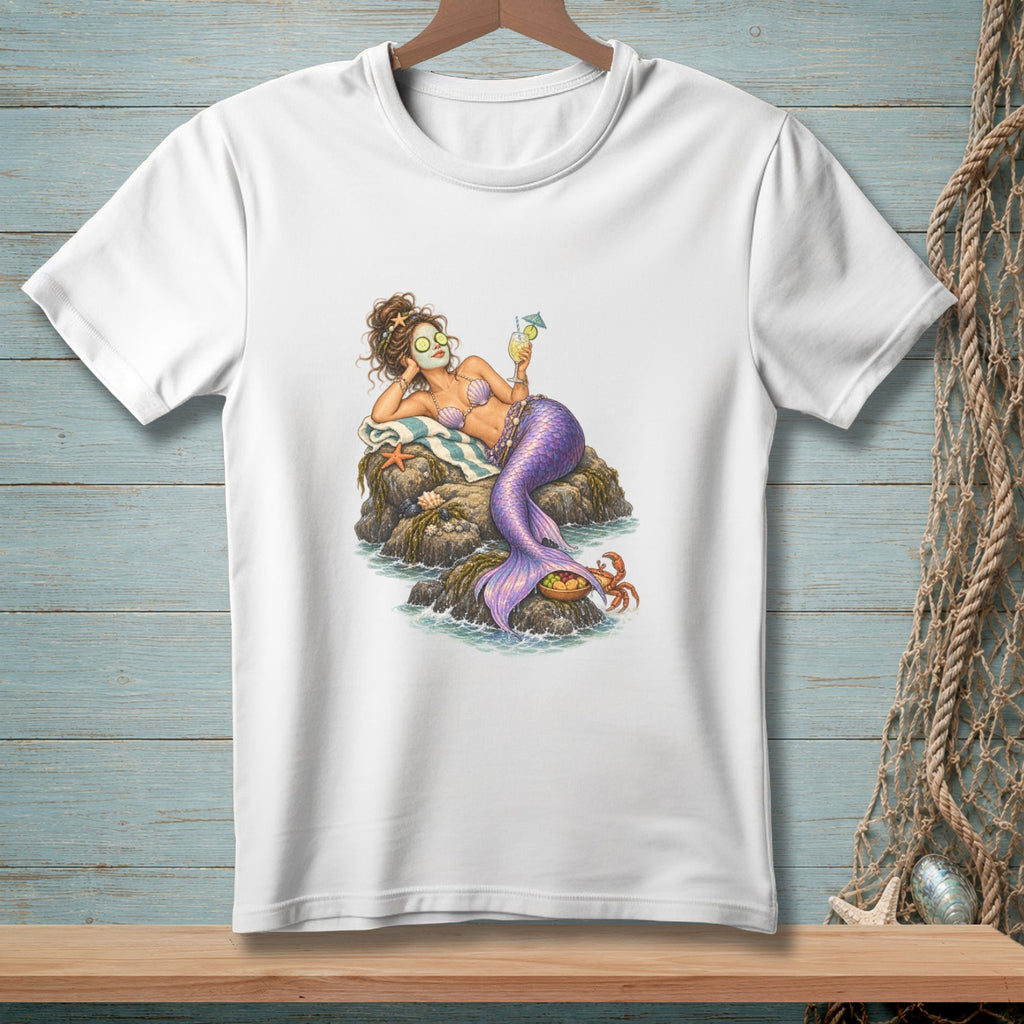 Illustration of a relaxed mermaid on a rock with a drink and cucumber eye patches.