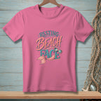 Pink t-shirt with "Resting Beach Face" text and mermaid tail graphic.