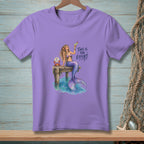 Purple t-shirt with a mermaid on a dock holding a drink and a crab.