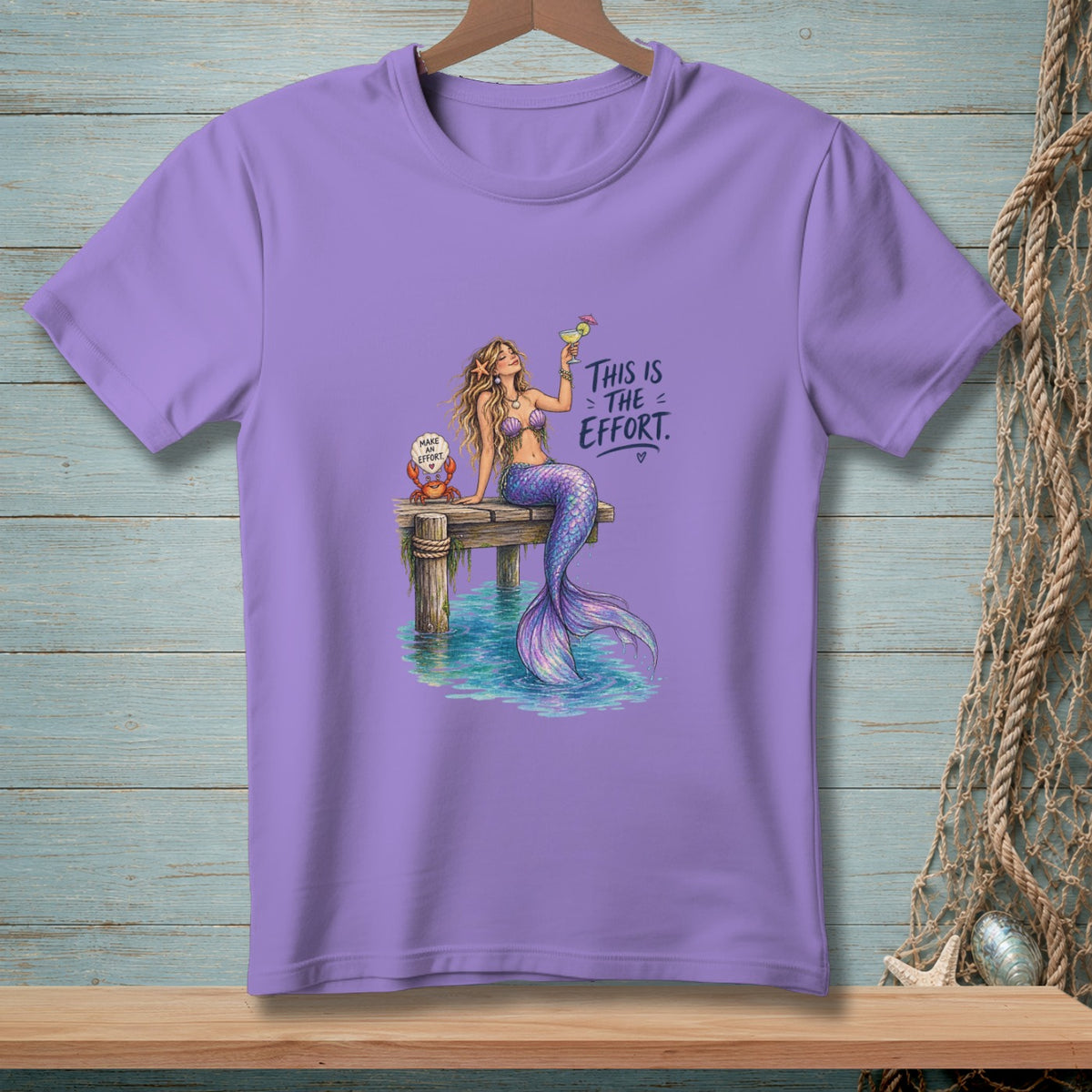 Purple t-shirt with a mermaid on a dock holding a drink and a crab.