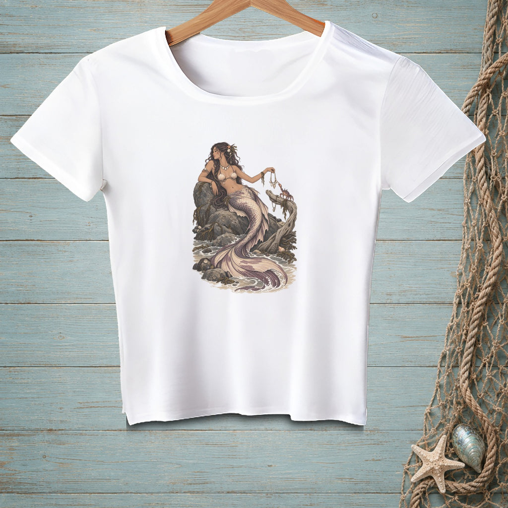 White t-shirt with graphic of a mermaid sitting on rocks holding jewelry.
