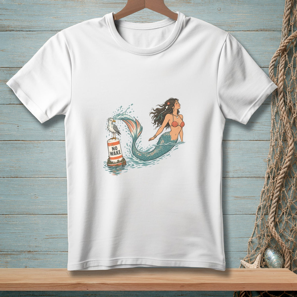 White t-shirt with a mermaid and a seagull on a "NO WAKE" buoy.
