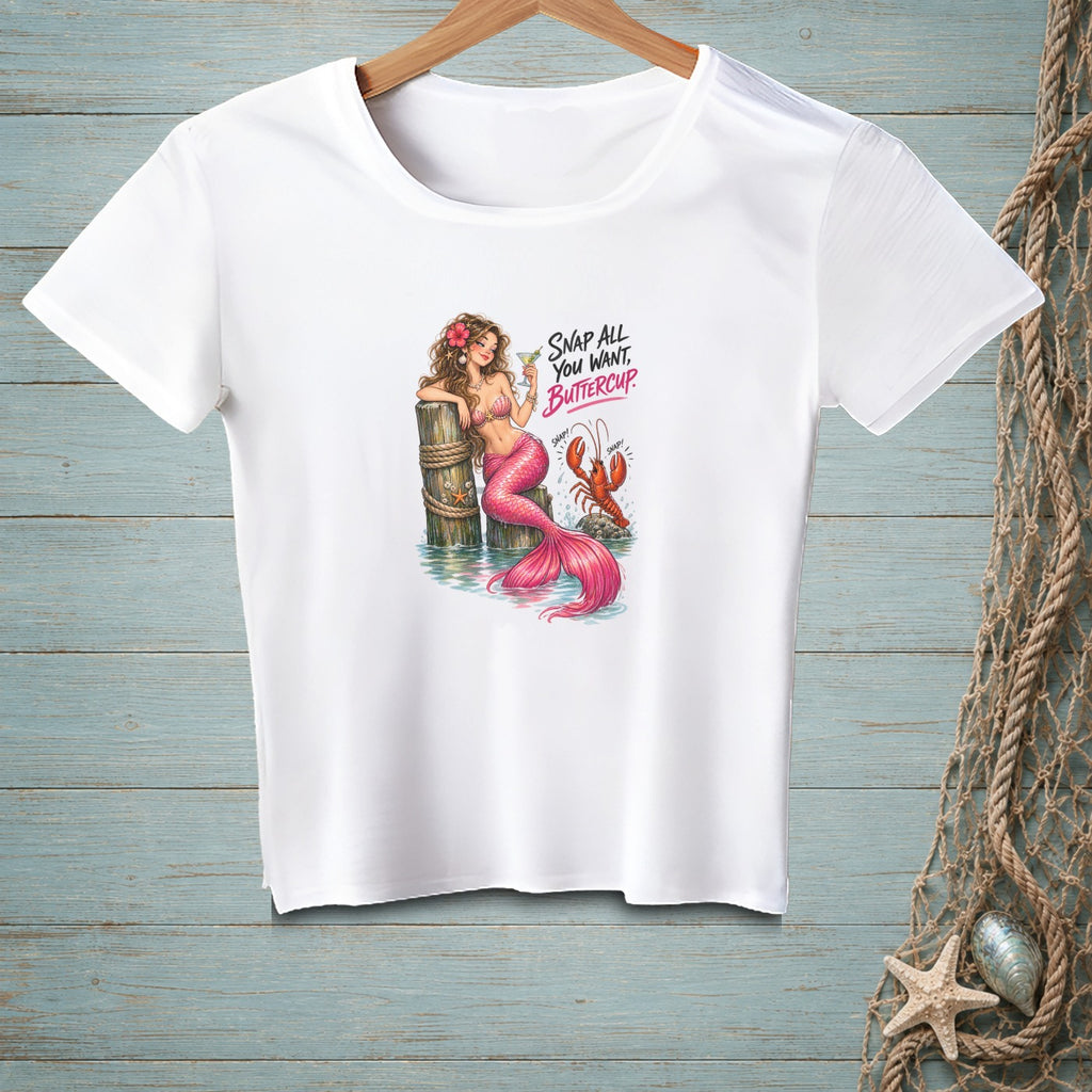 White t-shirt graphic of a mermaid and lobster with text "SNAP ALL YOU WANT, BUTTERCUP."