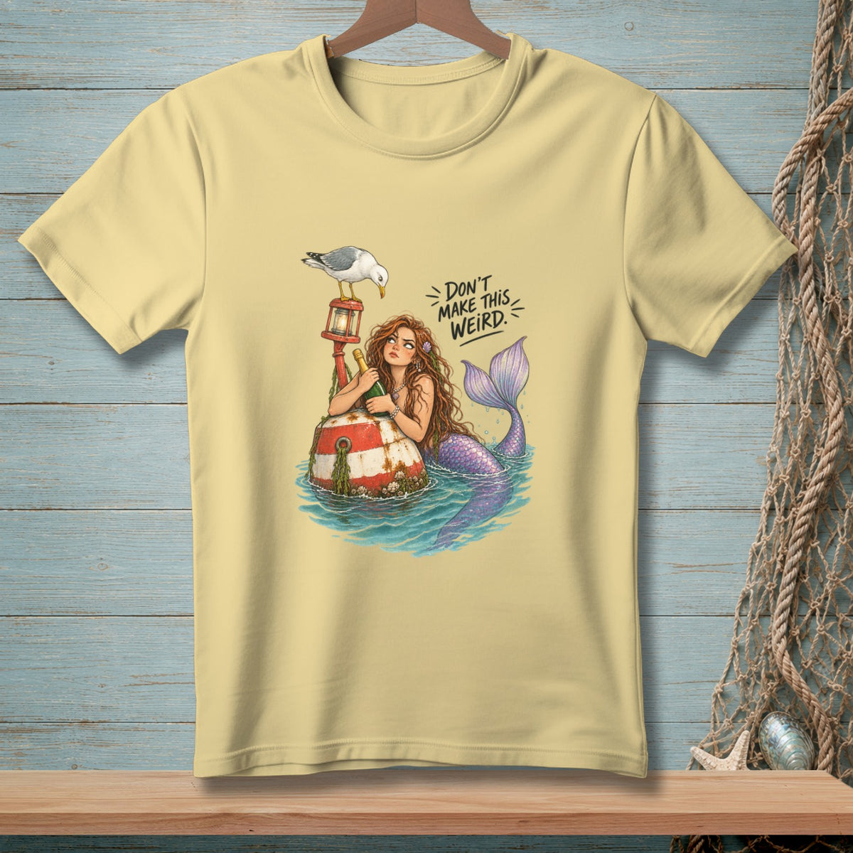 Mermaid with a bottle on a buoy, seagull, and text "DON'T MAKE THIS WEIRD."