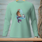 Mermaid under umbrella with dolphin and splashes on a light teal long sleeve shirt.