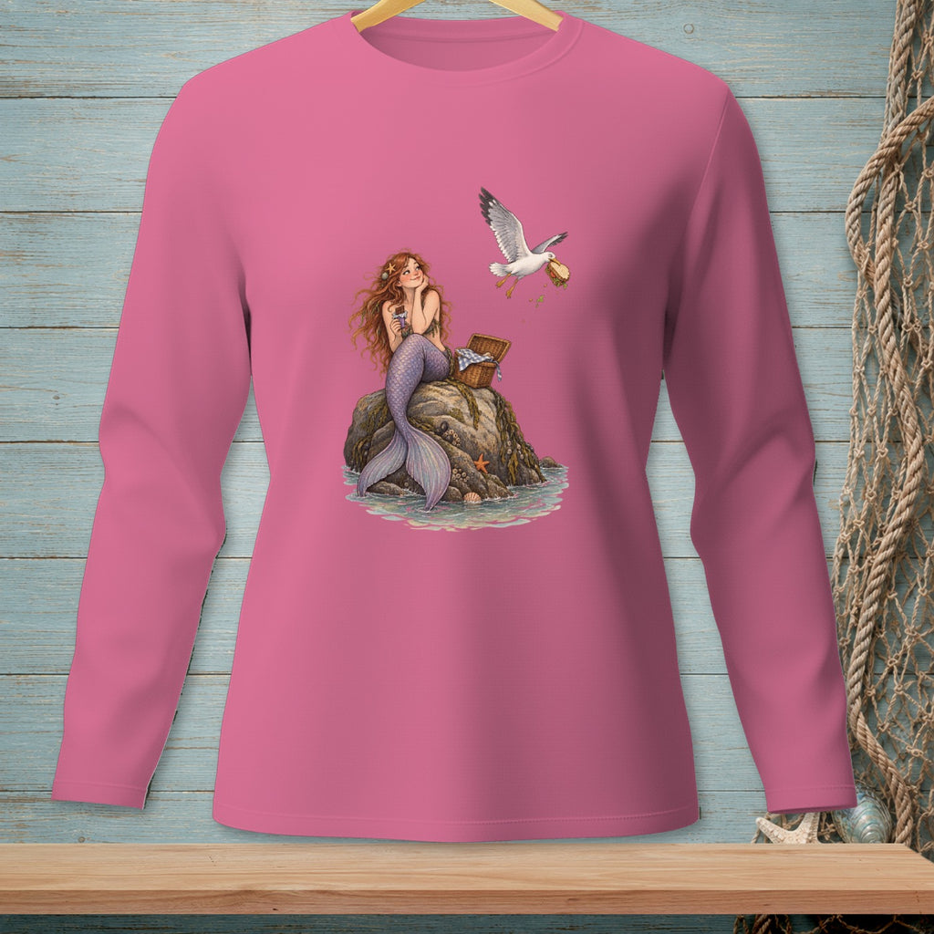 Mermaid sitting on a rock with a seagull stealing food from a picnic basket.