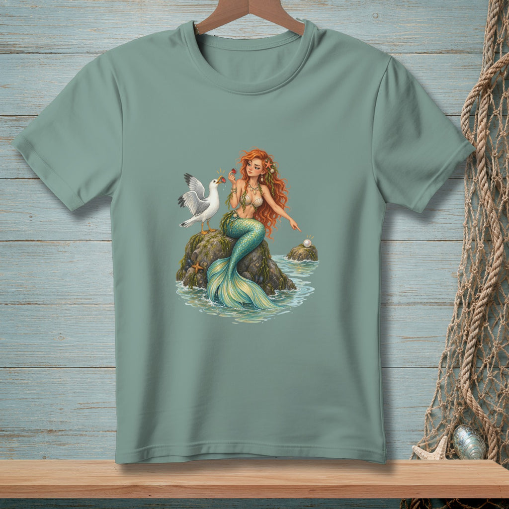 T-shirt featuring a mermaid with a bird and a pearl on a rock.