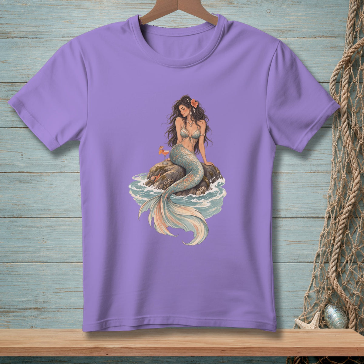 Purple t-shirt with illustration of a mermaid sitting on a rock.