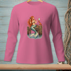Mermaid with red hair sits on a dock with a crab holding a mirror.