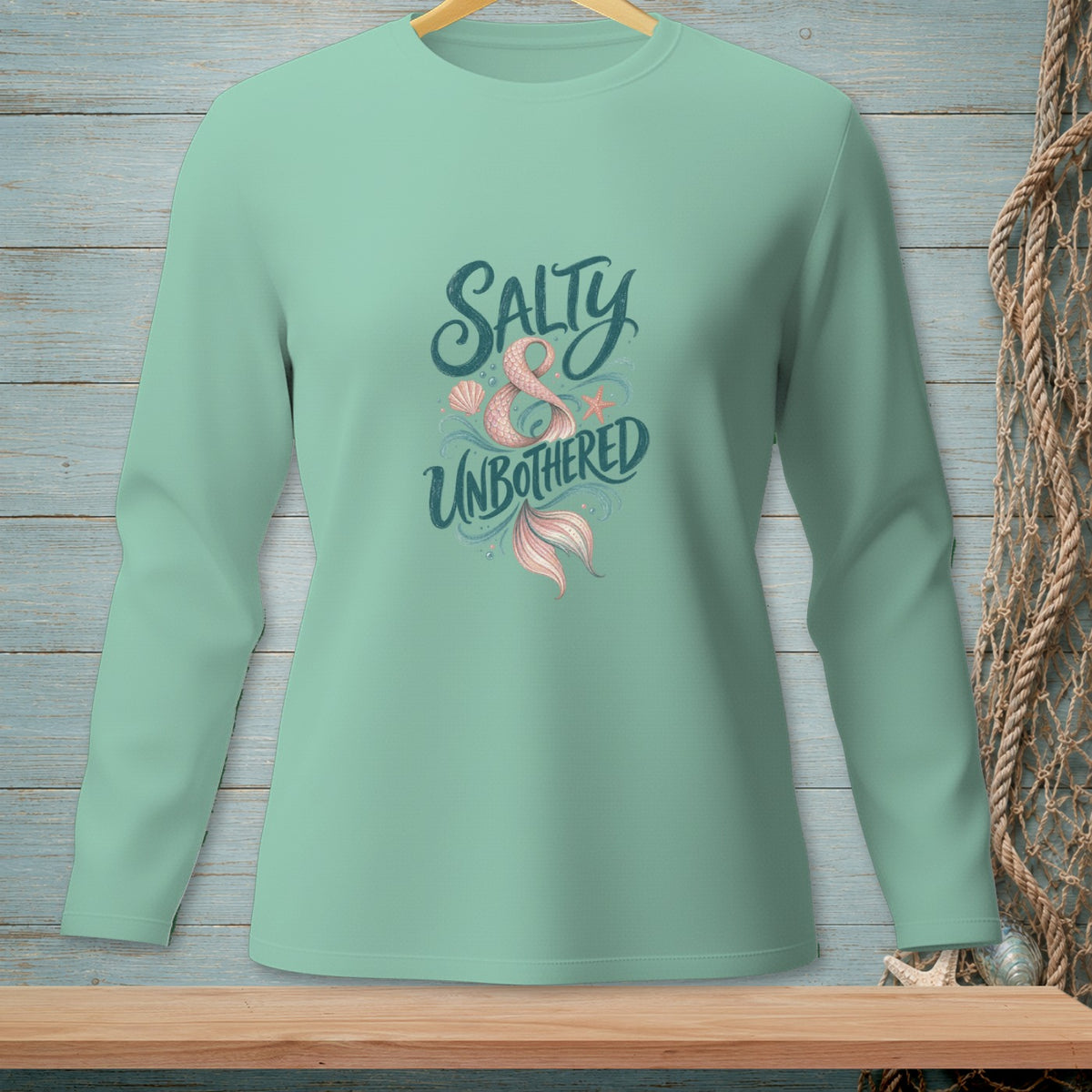 Mint green long sleeve shirt with "Salty & Unbothered" and mermaid tail graphic.