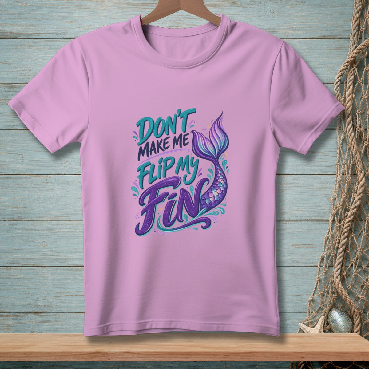 Lavender t-shirt with "Don't make me flip my fin" and mermaid tail graphic.