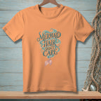 Orange t-shirt with "Mermaid Hair Don't Care" text and mermaid tail.