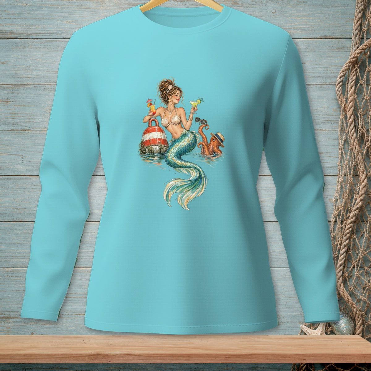 Aqua long-sleeve shirt with a mermaid, octopus, and buoy graphic.